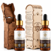 Amigos Power 100% natural Moroccan argan oil 30ml amber dropper bottles next to intricately carved protective wooden packaging boxes against a clean white background.